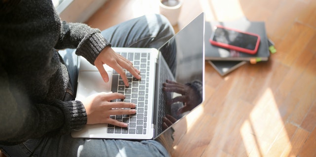 woman sitting on floor with computer